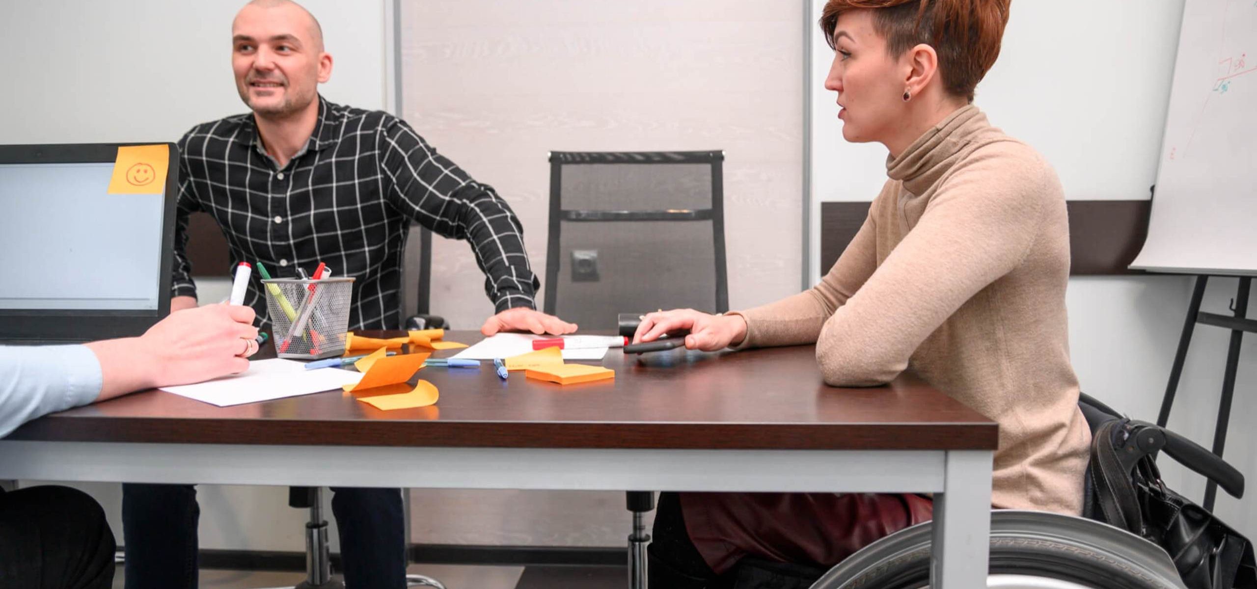 handicapped-young-woman-office-desk (1) (1)